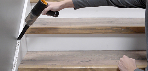 Vacuuming the stair trim board