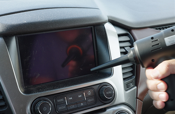 Vacuuming a car dashboard display