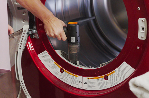 Vacuuming the lint trap of a dryer